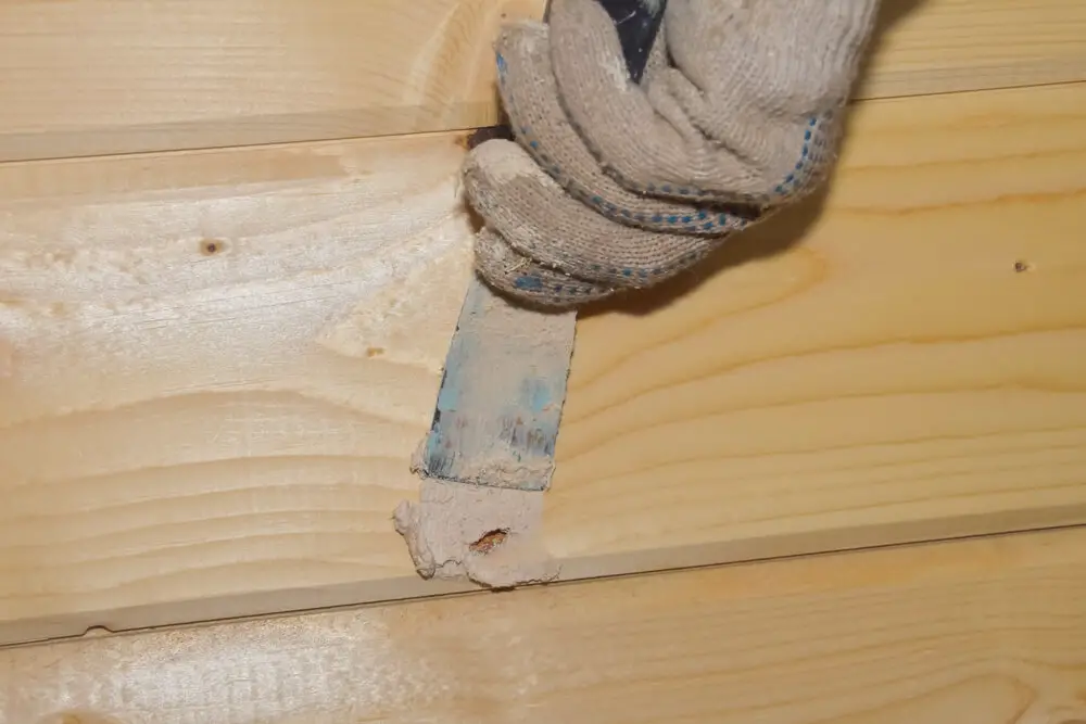 putty on wooden wall hole